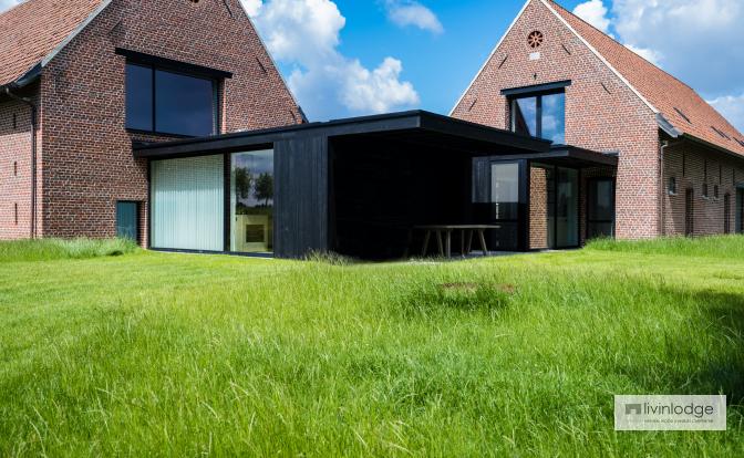 Modern timber-frame extension in charred wood Modern timber-frame extension in charred wood
