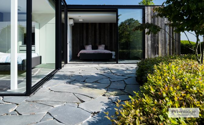 The guest space in the wooden outbuilding features large windows The guest space in the wooden outbuilding features large windows